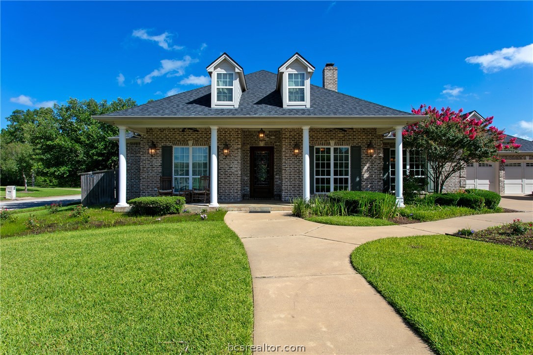 a view of a house with garden and porch