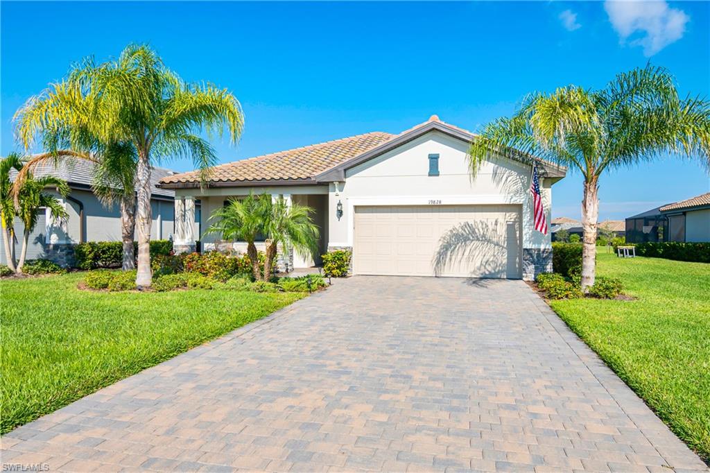 a front view of a house with a garden and yard