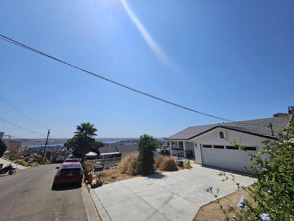 a front view of a house with cars