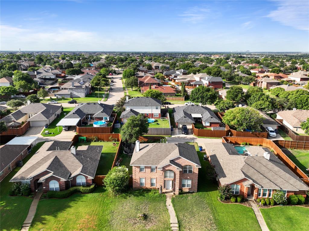 an aerial view of residential houses with outdoor space