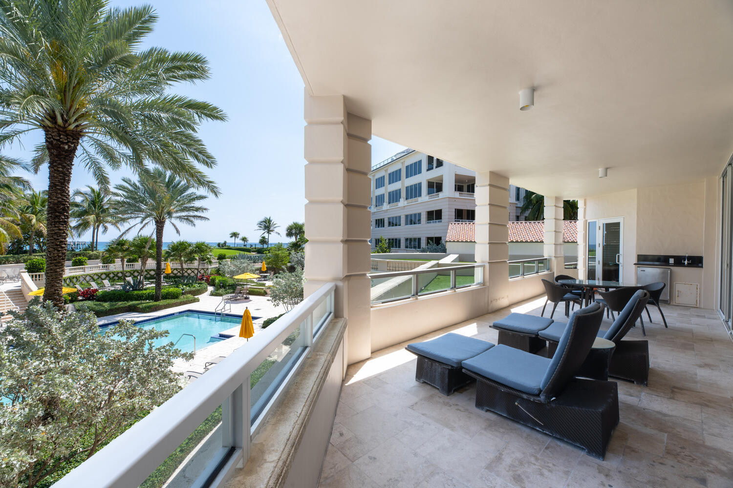 a balcony with furniture and a yard