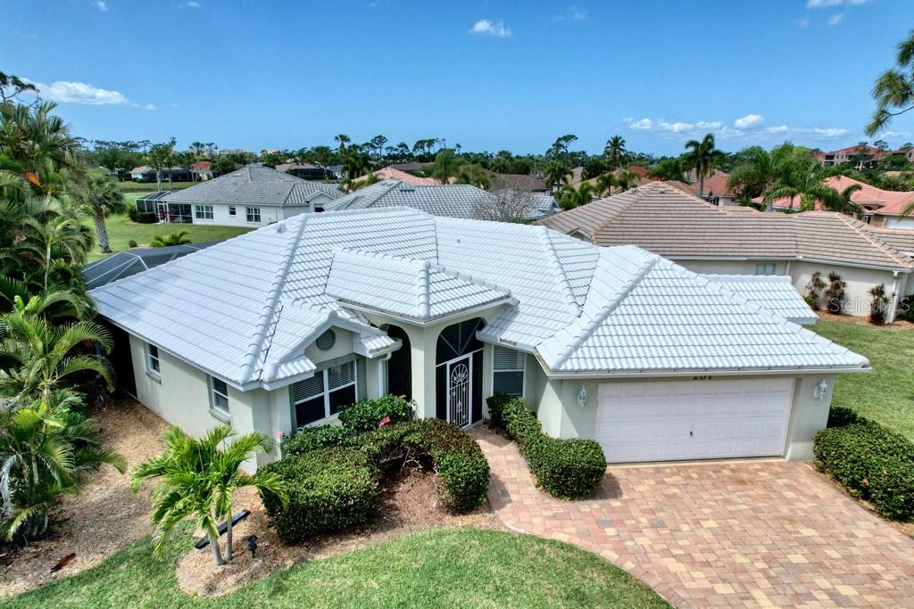 an aerial view of a house with yard and green space