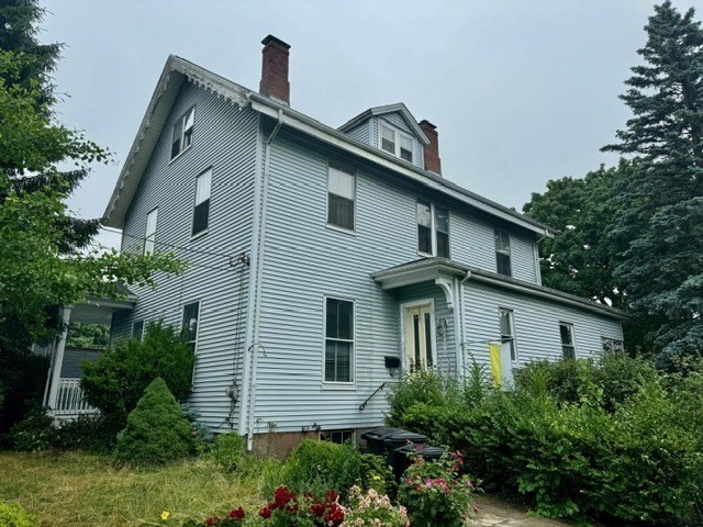 a front view of a house with plants