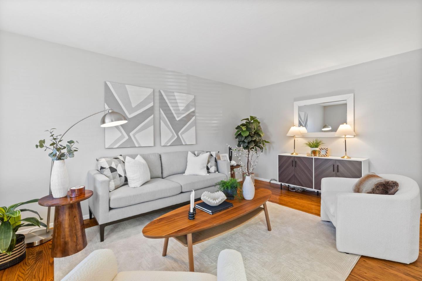 a living room with furniture and a potted plant