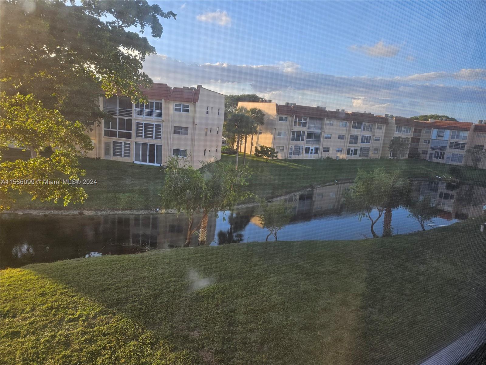 a view of swimming pool of water with lawn chairs and lake view