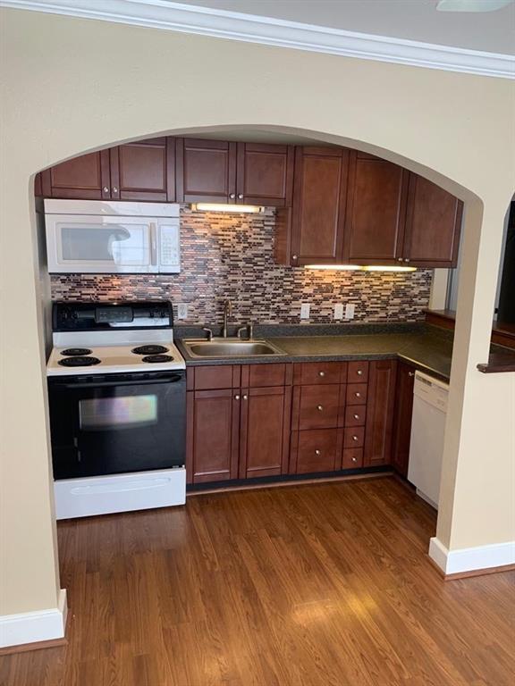 a kitchen with stainless steel appliances granite countertop a stove and a sink