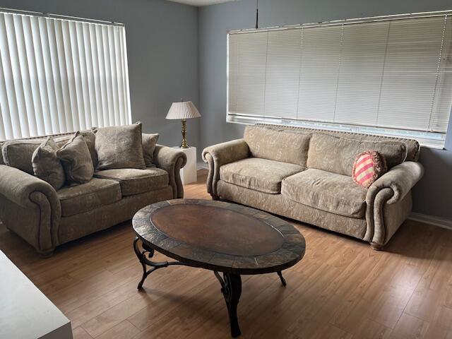 a living room with furniture and a wooden floor