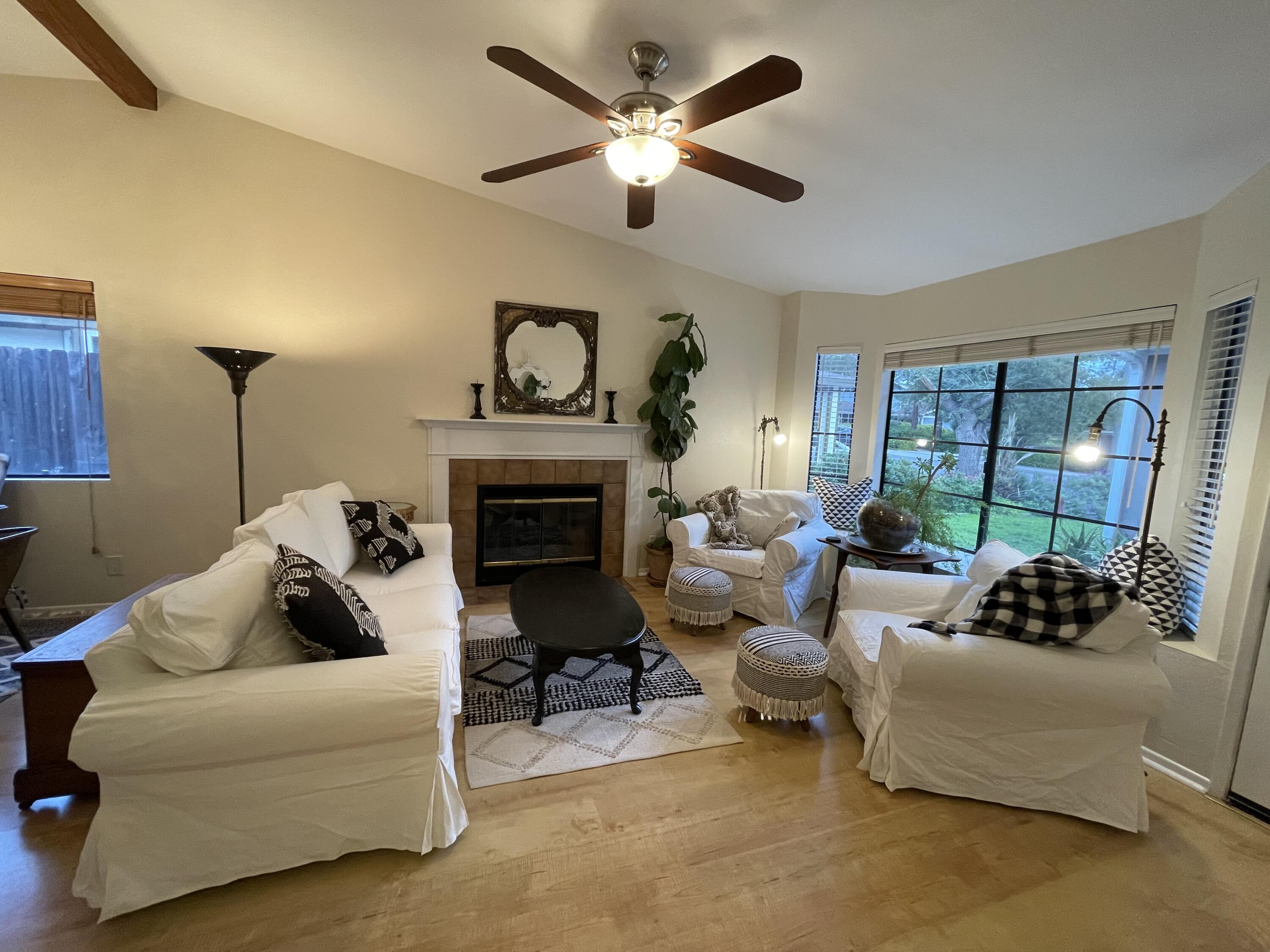 a living room with furniture and a fireplace