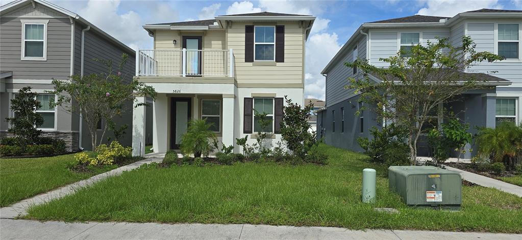 a front view of house with a garden