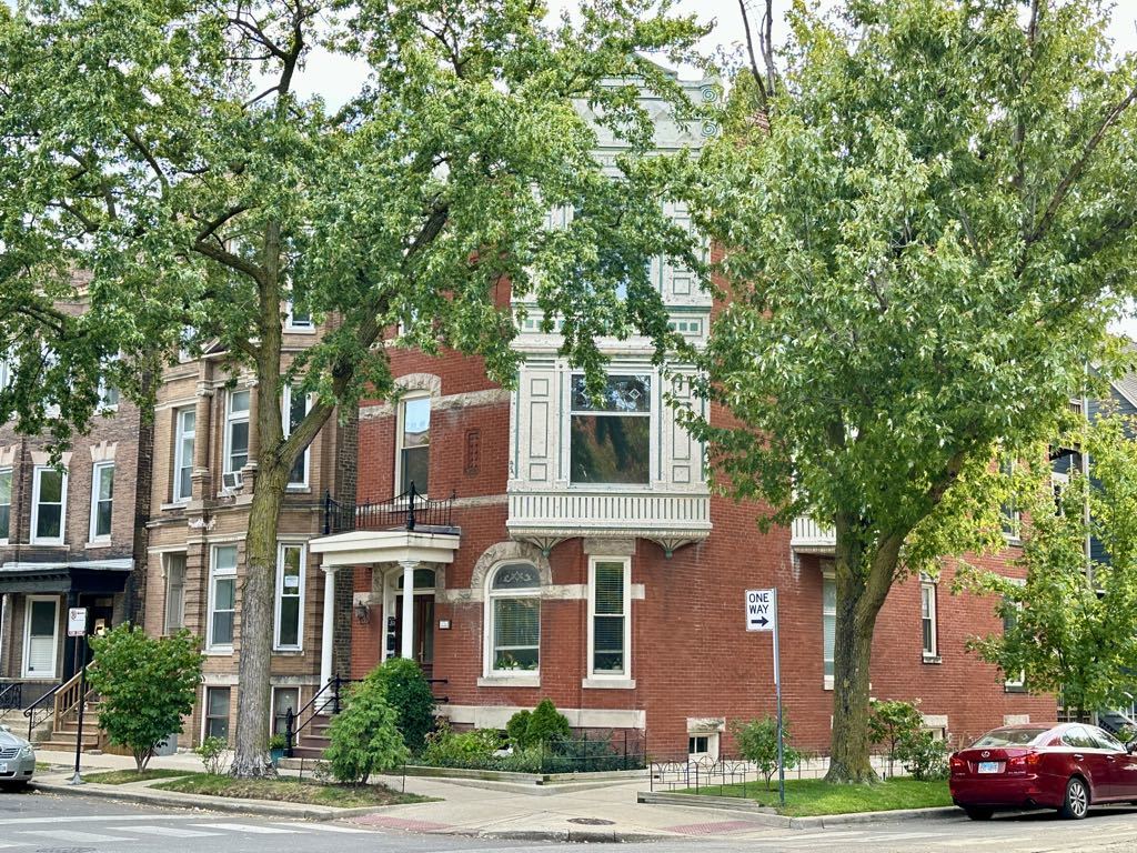 a front view of a residential apartment building with a yard