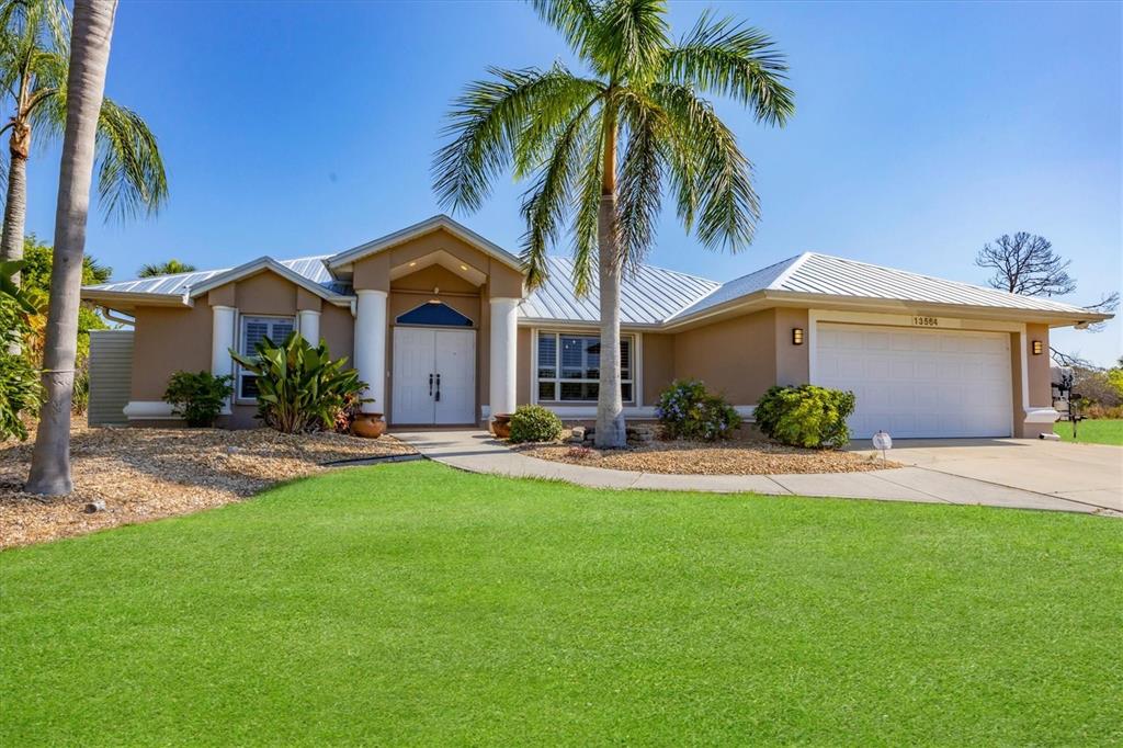 a front view of house with yard and outdoor seating