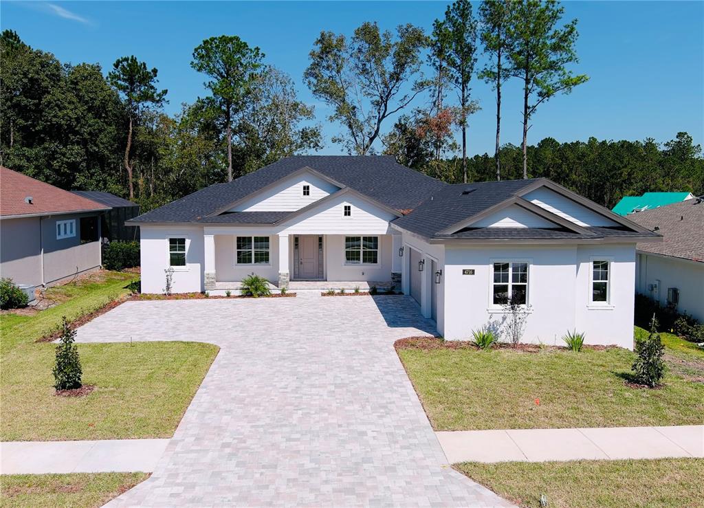 a front view of house with yard and green space