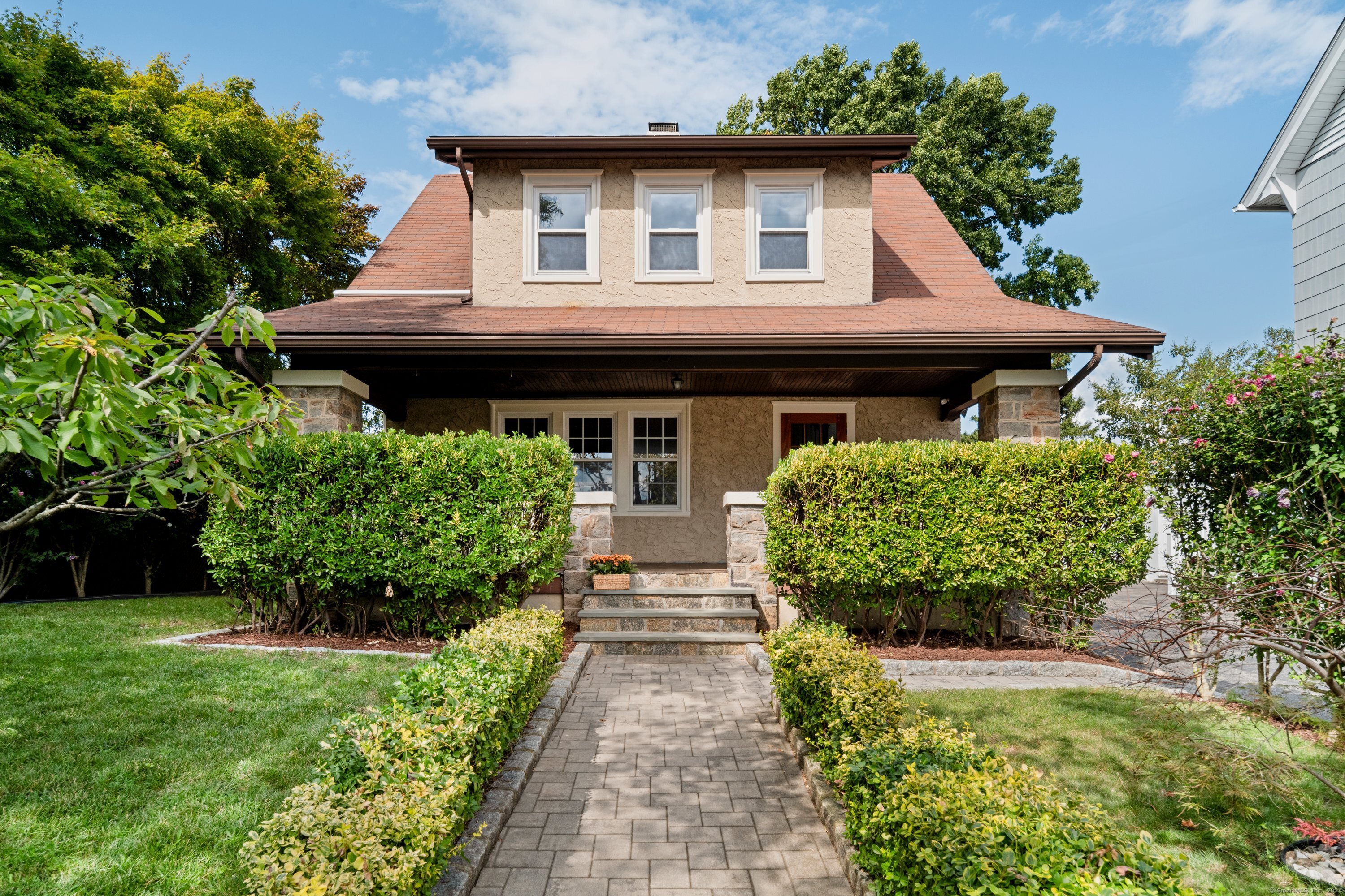 a front view of a house with garden