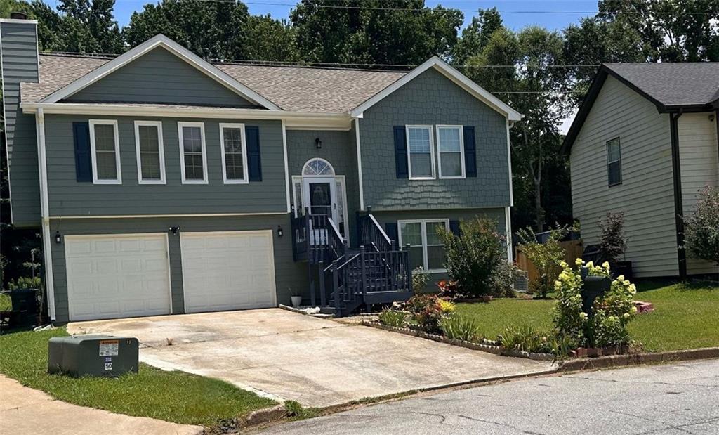 a front view of a house with a yard and garage