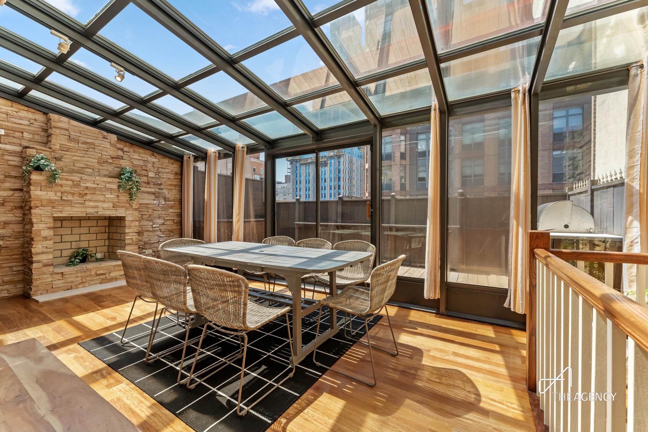 a dining room with stainless steel appliances granite countertop a rug a stove and a refrigerator