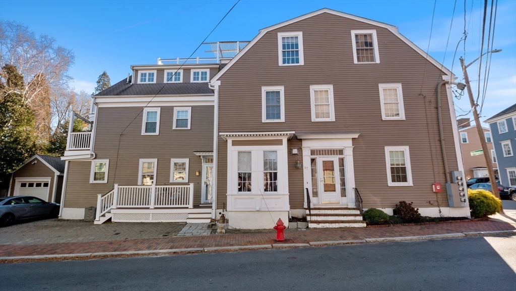 a front view of a house with a road