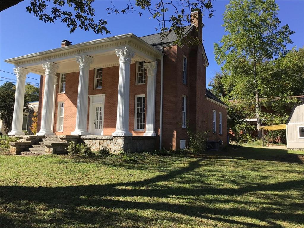 a view of a house with a small yard