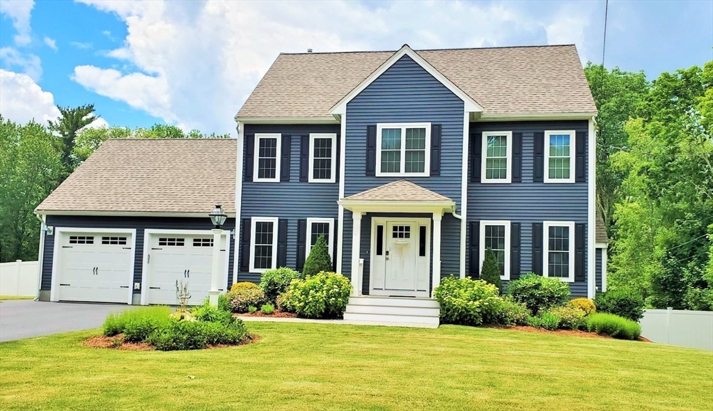 a front view of a house with garden and porch