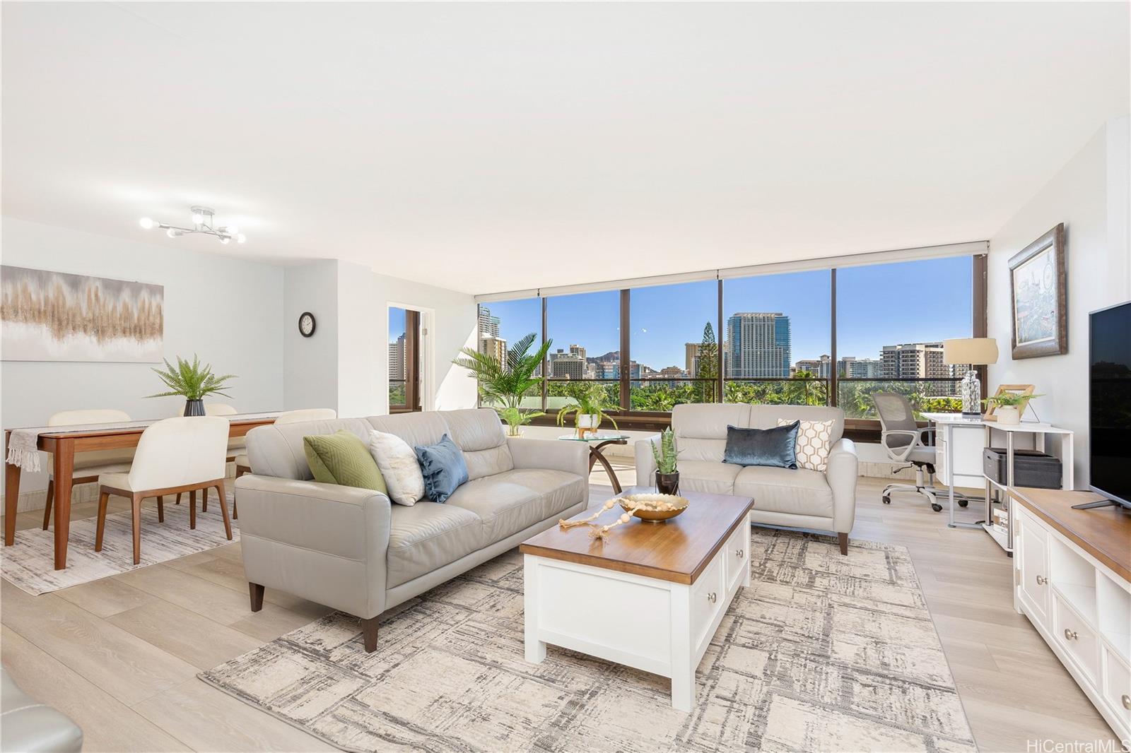 a living room with furniture and a view of kitchen