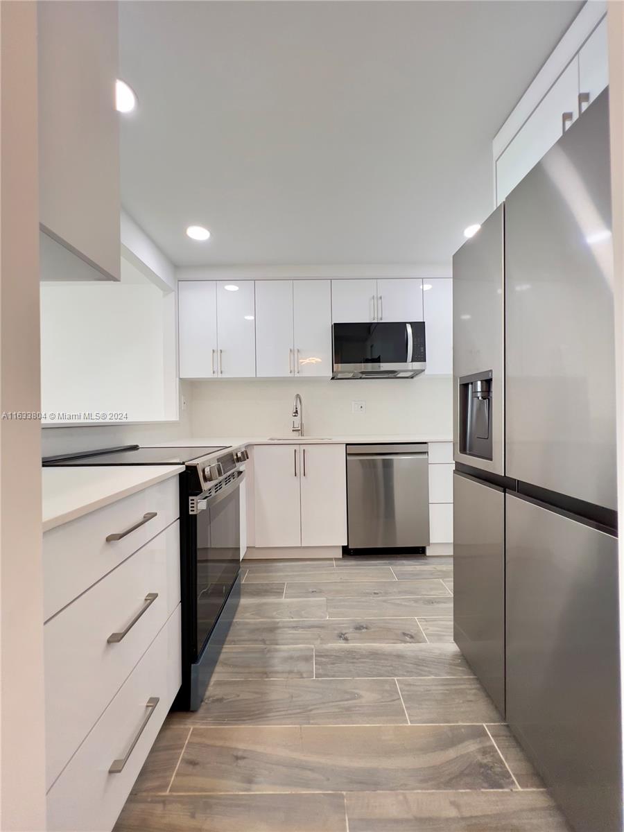 a kitchen with a refrigerator stove and microwave