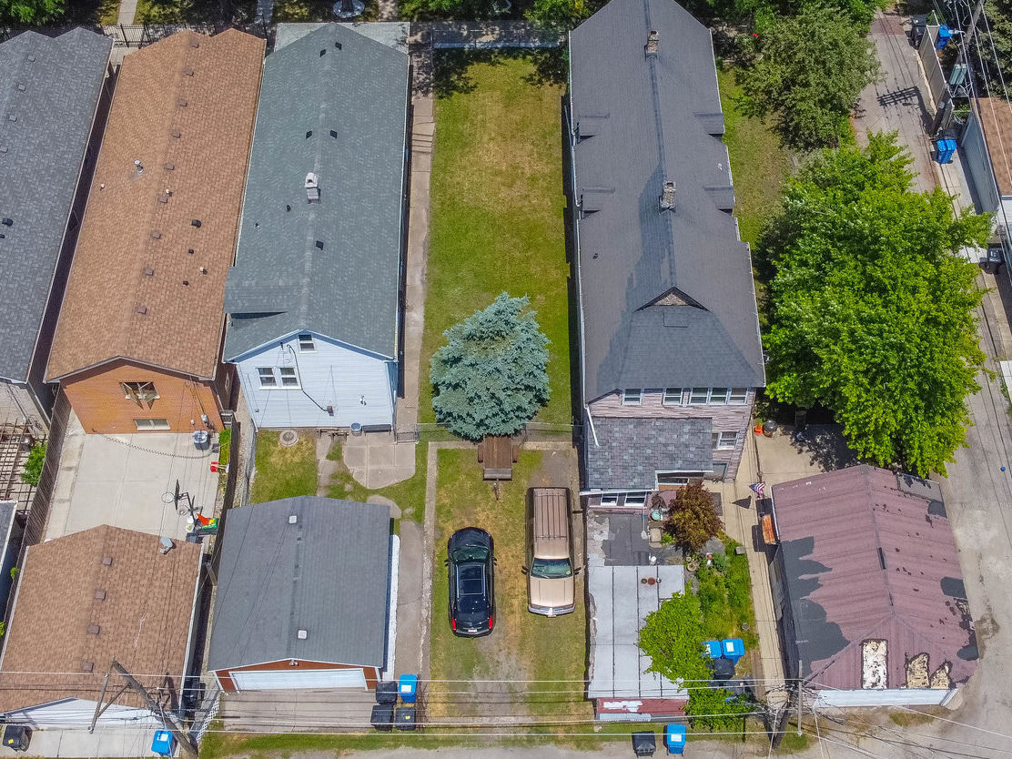 an aerial view of residential houses with outdoor space