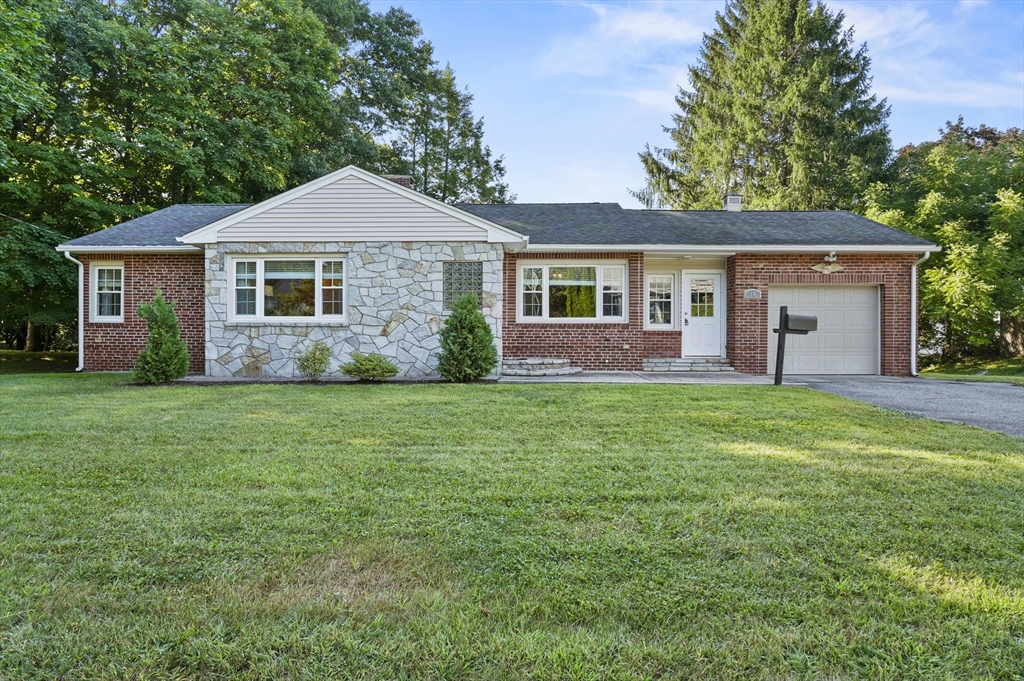 a front view of house with yard and green space