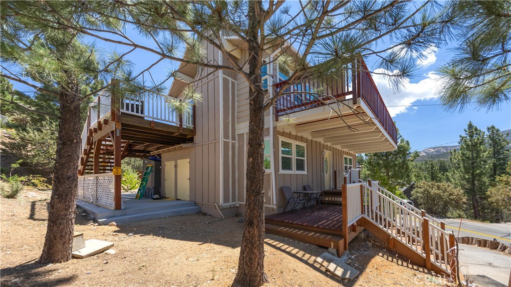 a view of a house with a tree beside of it