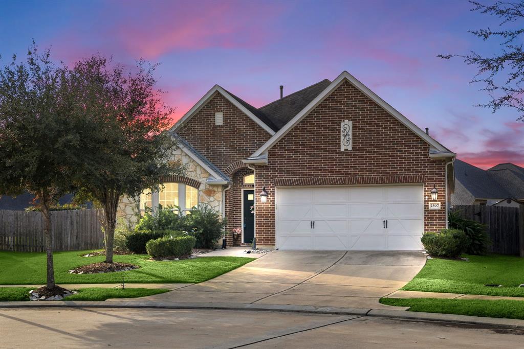 a front view of a house with a yard and garage