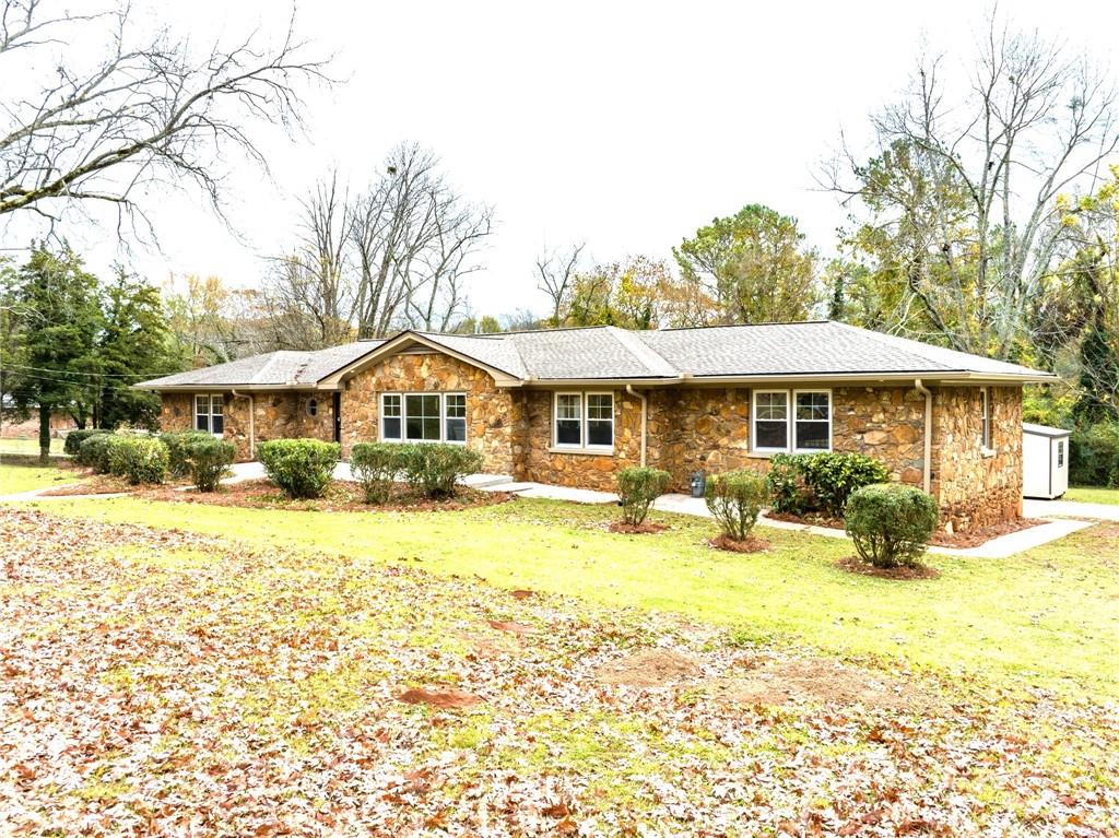 a front view of a house with a yard patio and swimming pool