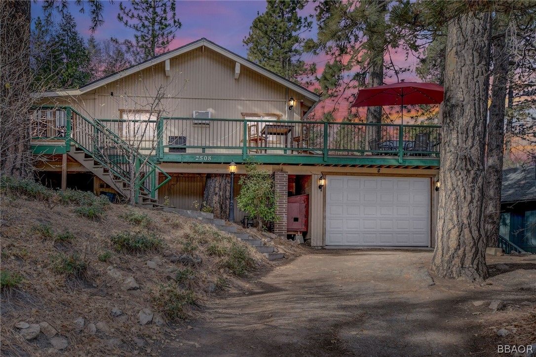 a front view of house with yard and outdoor seating