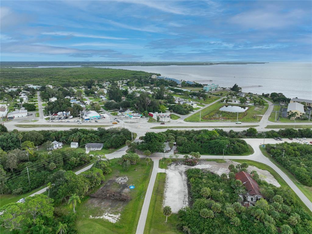 an aerial view of residential houses with outdoor space and river