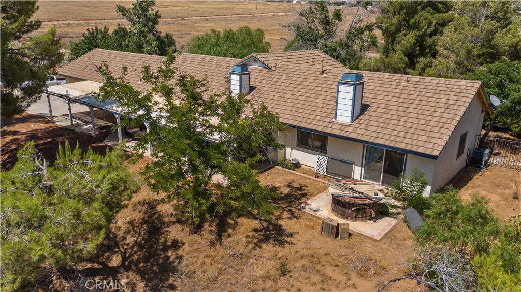 a view of a house with a yard and sitting area