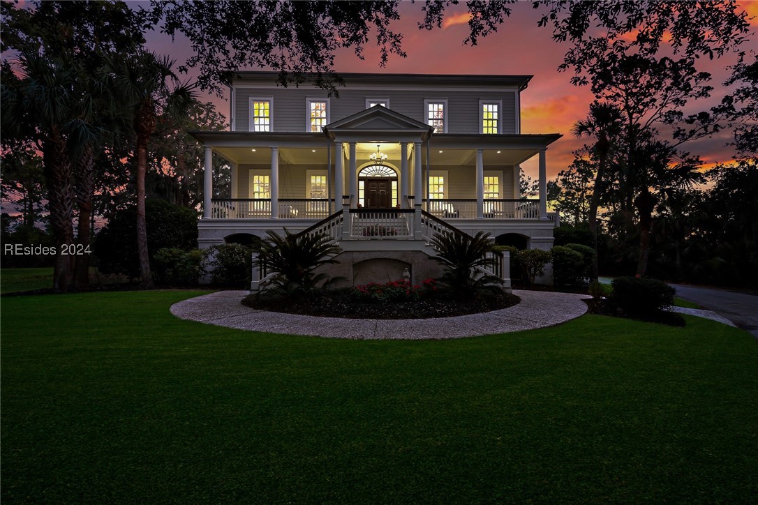 View of front facade featuring a yard and a porch