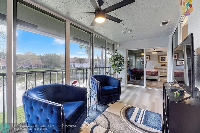 a living room with furniture and a floor to ceiling window