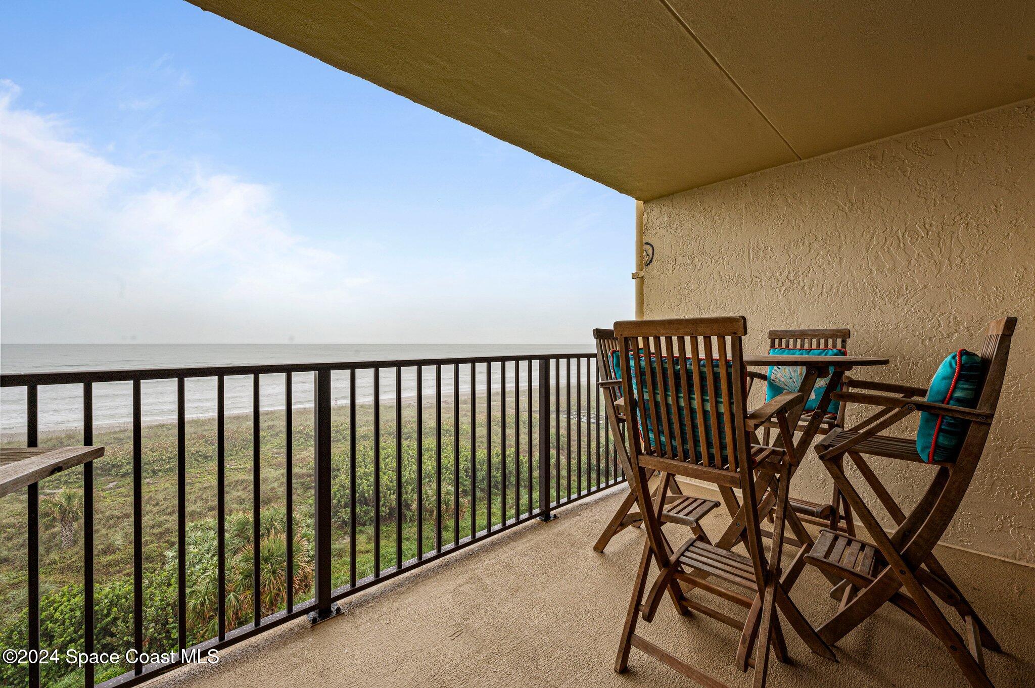 a view of balcony with furniture