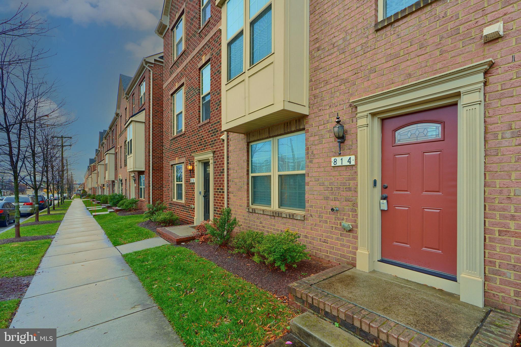 a view of a brick building next to a yard