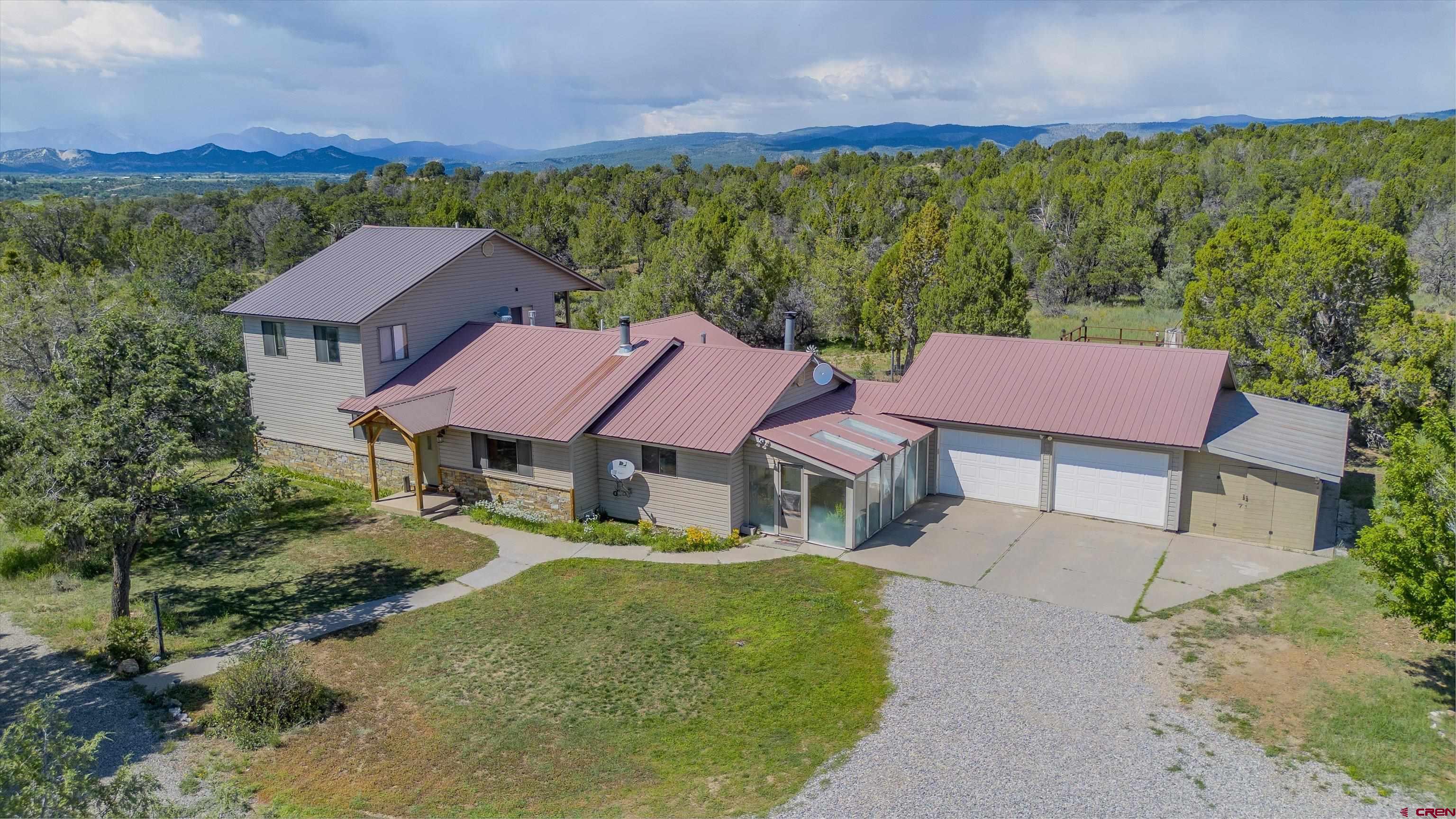 a aerial view of a house with a yard and lake view