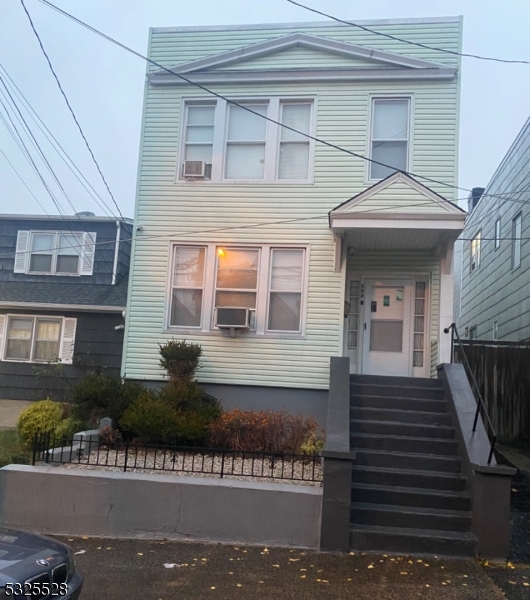 a view of a house with more windows and a small yard