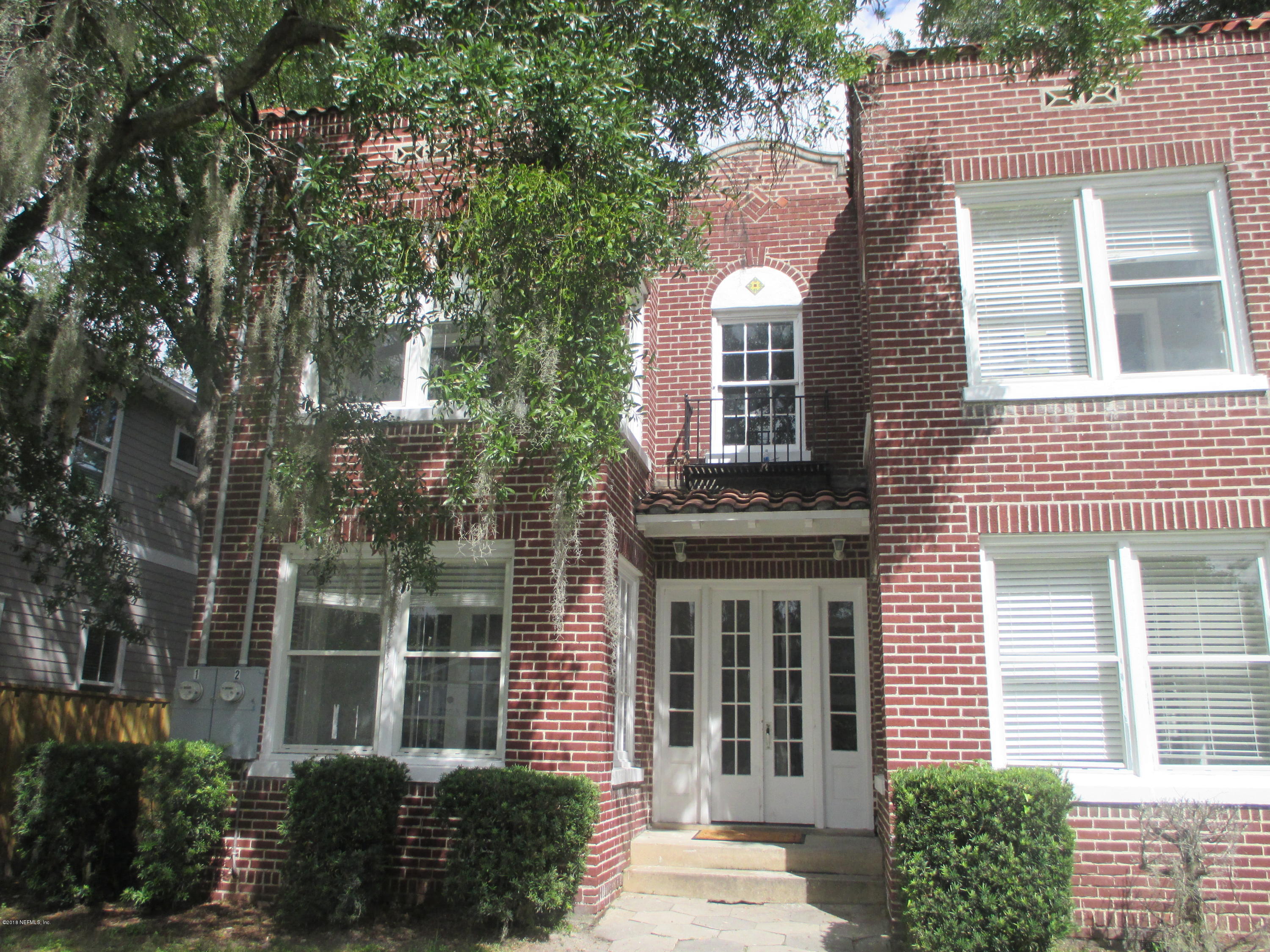 a view of a brick house with a large windows