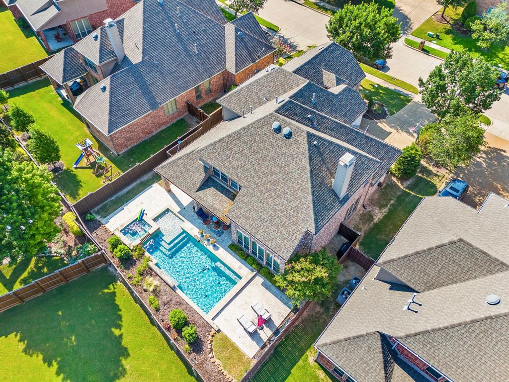 an aerial view of a house with a garden and swimming pool