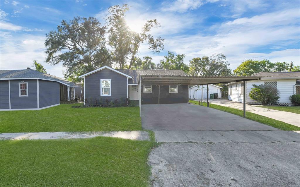 a front view of a house with a garden and yard