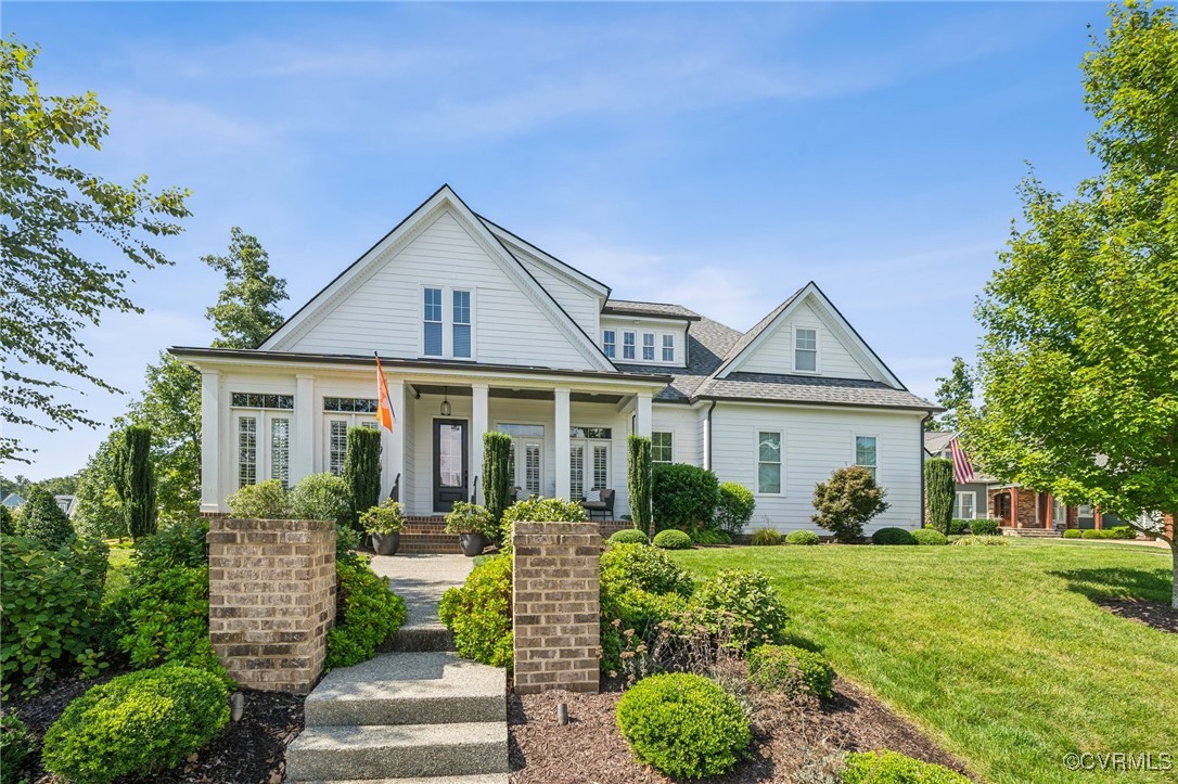 View of front of home featuring a front lawn and c