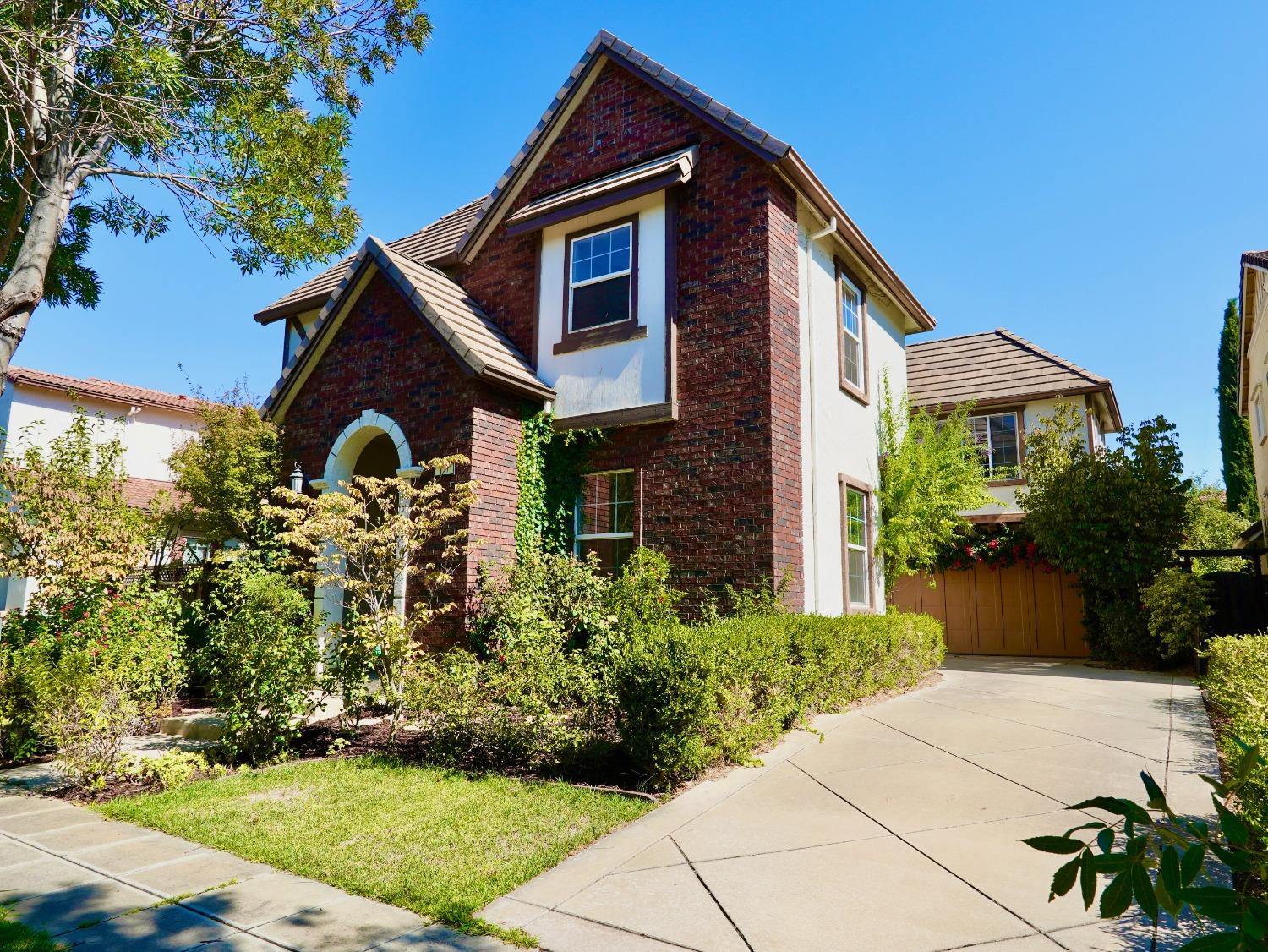 a front view of a house with garden