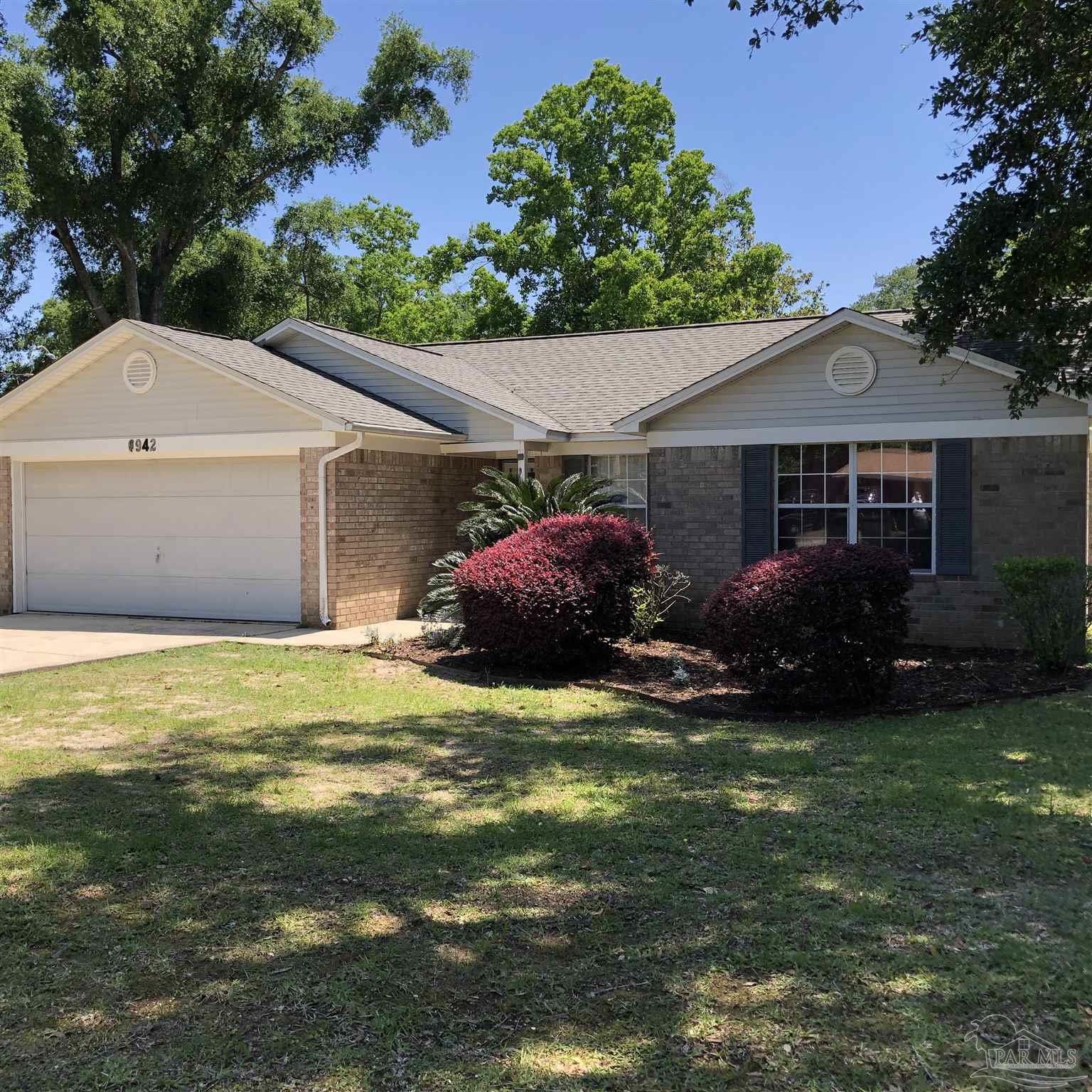 a view of a house with a yard and garage