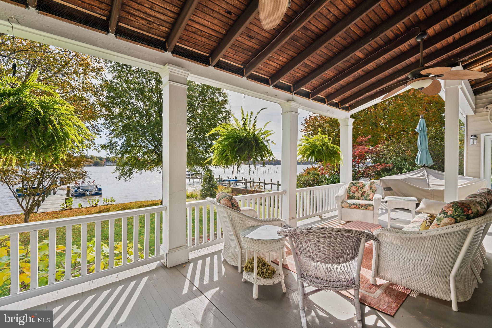 a view of a patio with a table chairs and wooden floor