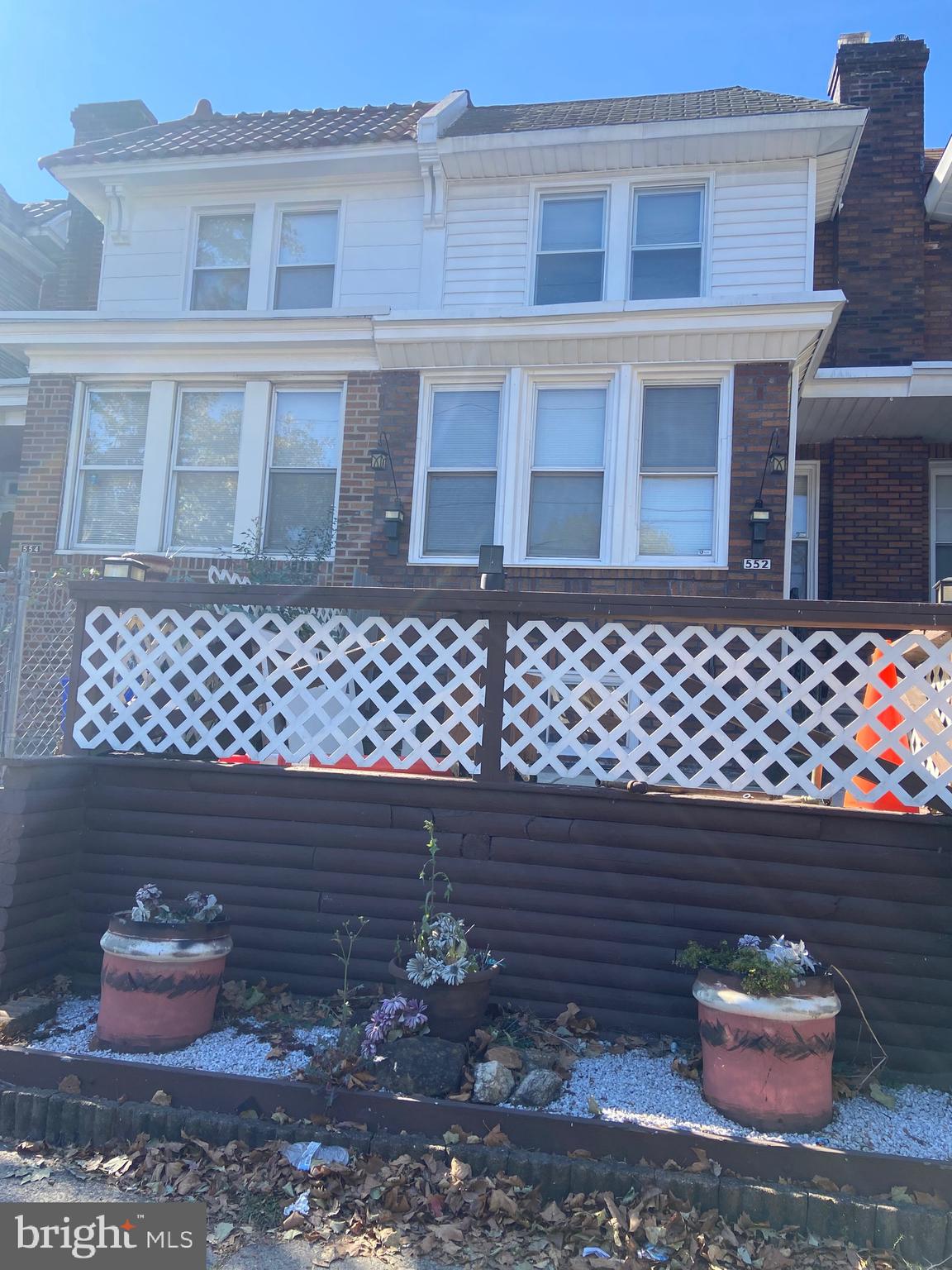 a couple of potted plants sitting in front of a house