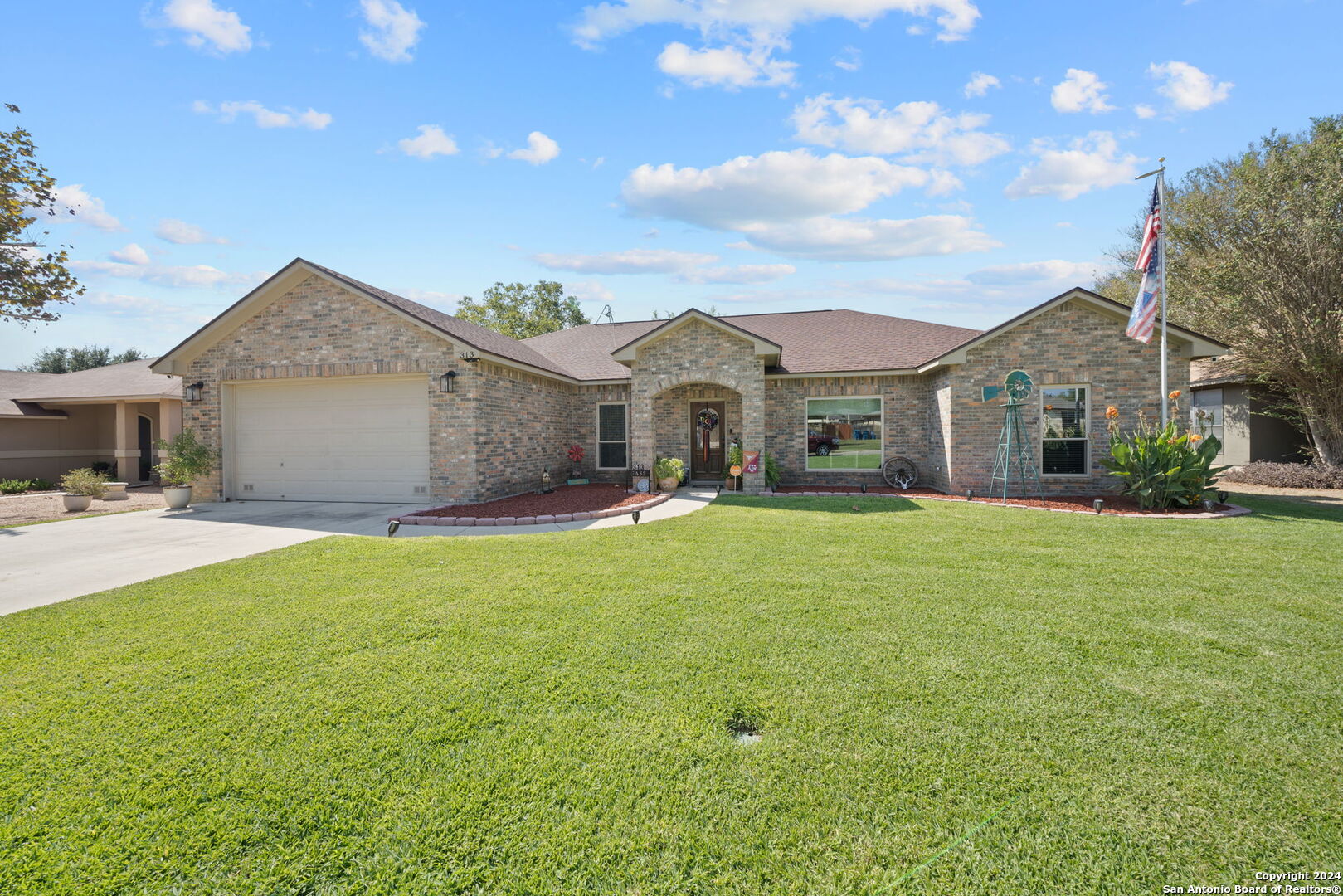 a front view of a house with a garden and yard