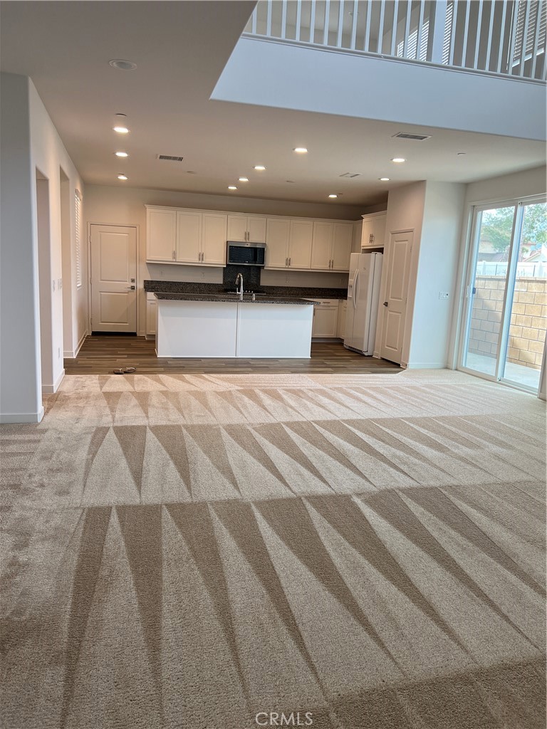 a large white kitchen with a white countertops