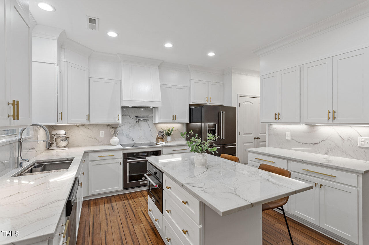 a kitchen with a sink stove and refrigerator