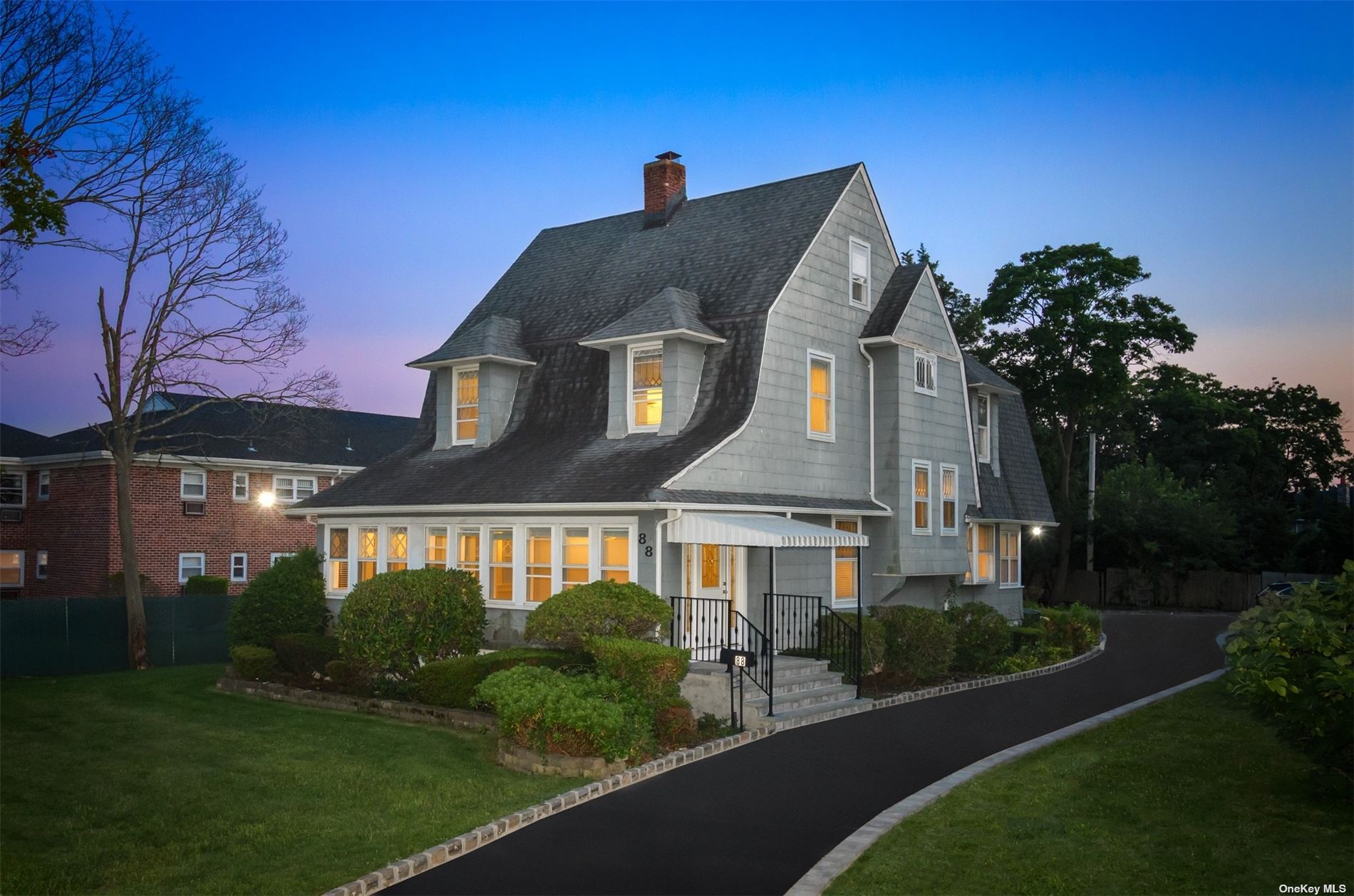 a front view of a house with a garden